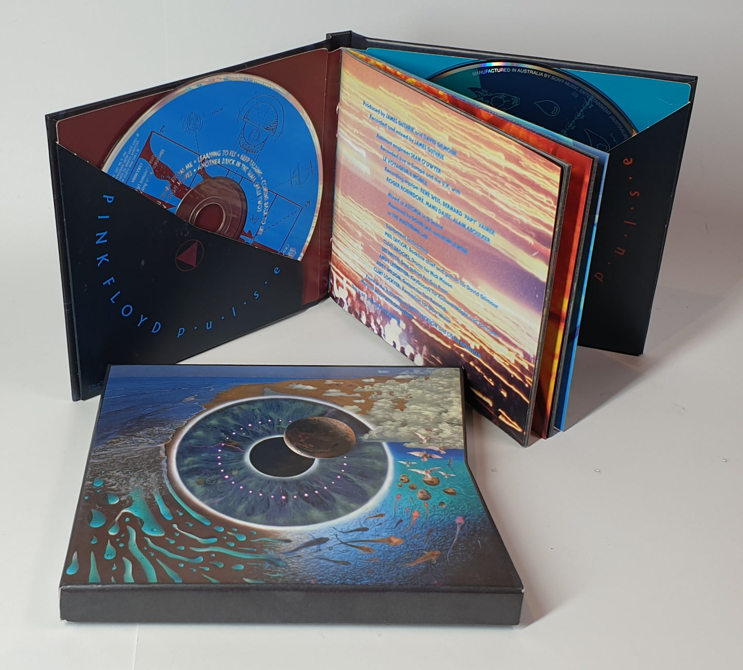 Pink Floyd album with open cover displaying colorful design and text.