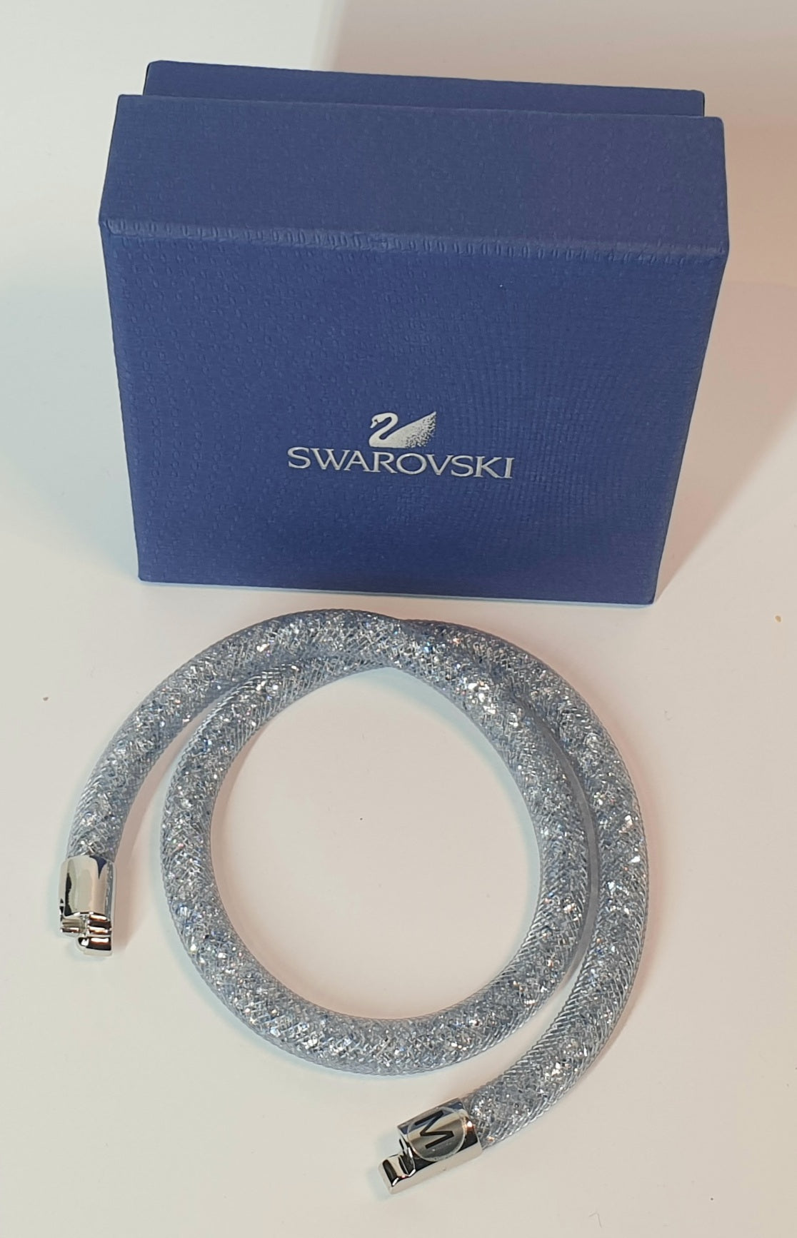 Silver bracelet with Swarovski logo on a blue box