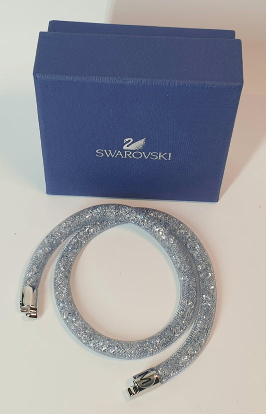 Silver bracelet with Swarovski logo on a blue box