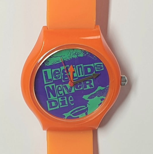 Vision Street Wear - Orange watch with a purple face displaying 'Legends Never Die' on a white background