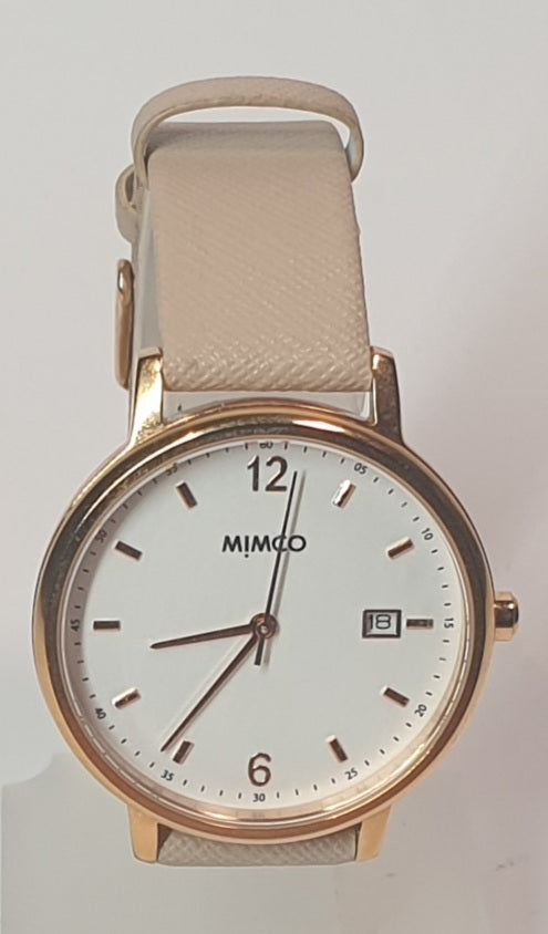 MIMCO Wristwatch with beige strap and white face on a light gray background