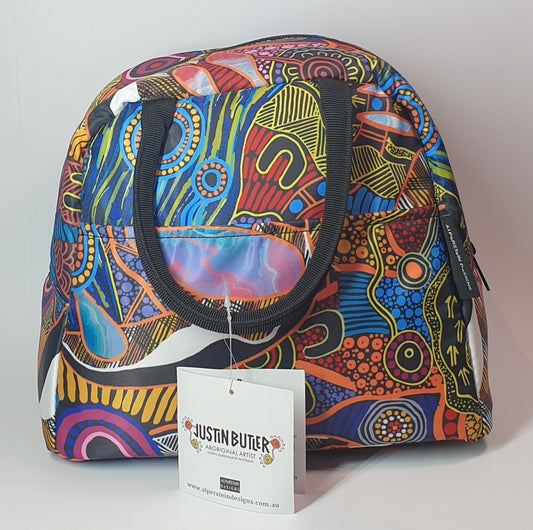 Justin Butler Lunch Tote, Colourful patterned bag with a Justin Butler tag on a light gray background