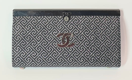 Chanel wallet with geometric pattern and logo on a white background