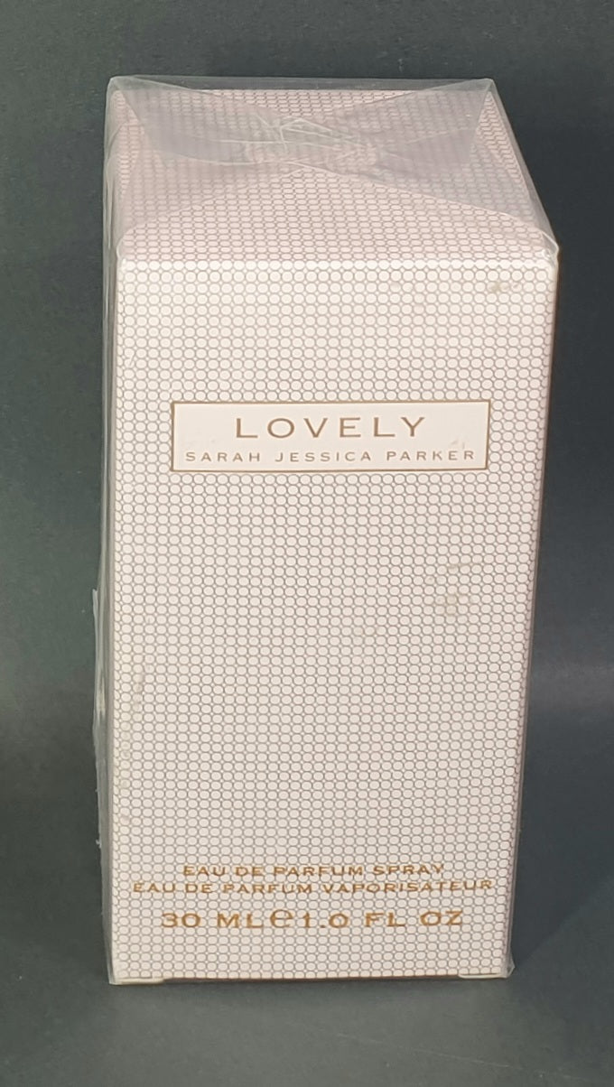 Eau de Parfum spray bottle packaging with 'Lovely' branding on a dark background