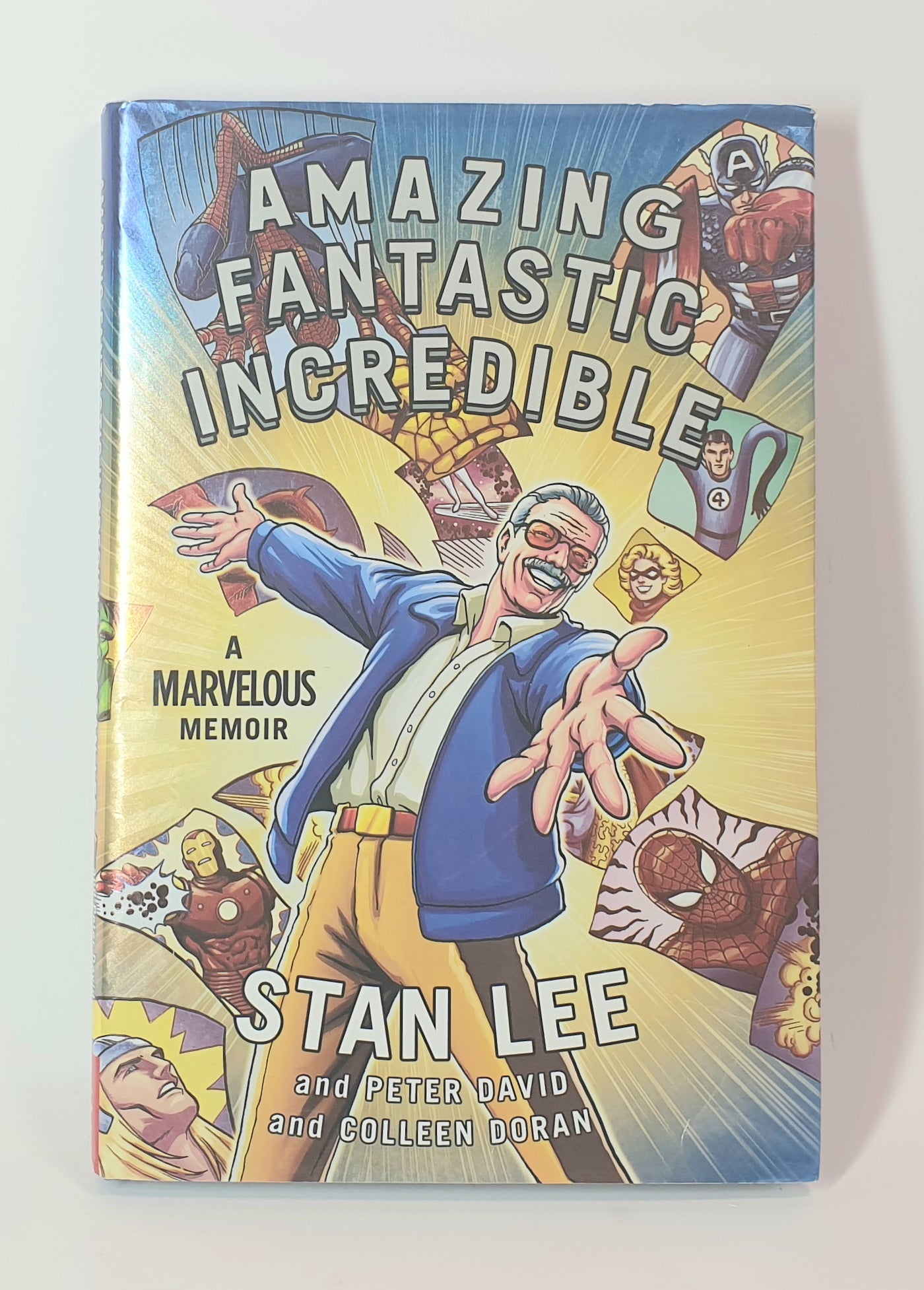 Book cover of 'Amazing Fantastic Incredible' by Stan Lee with superhero graphics.