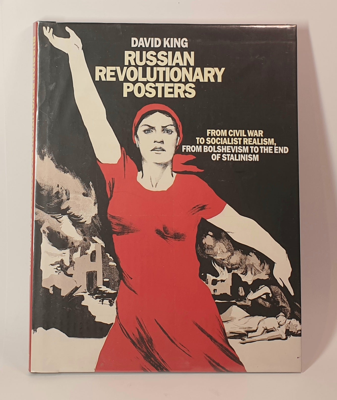 Book cover of 'Russian Revolutionary Posters' by David King with a woman in a red dress on a black background.