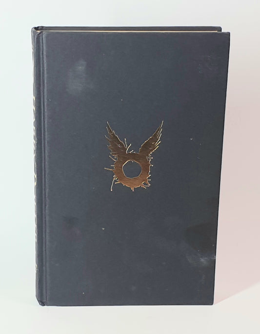 The Dark blue book of Harry Potter with a gold emblem on a white background