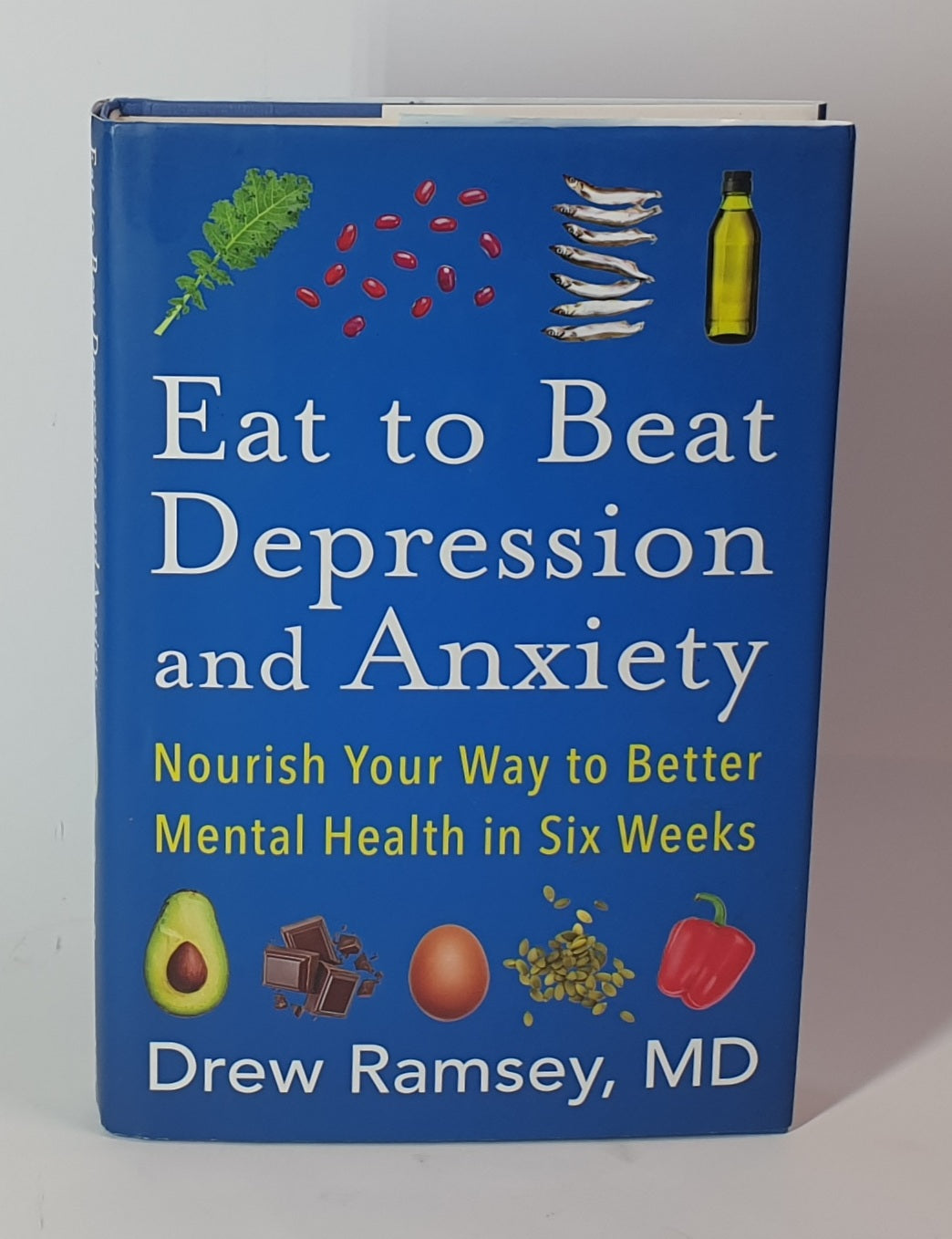 Book titled 'Eat to Beat Depression and Anxiety' by Drew Ramsey, MD on a white background
