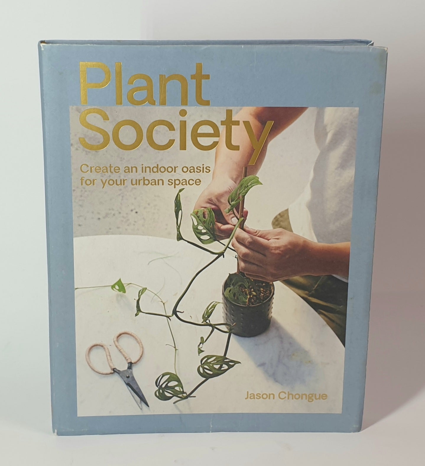 Book titled 'Plant Society' with a person interacting with plants on the cover.