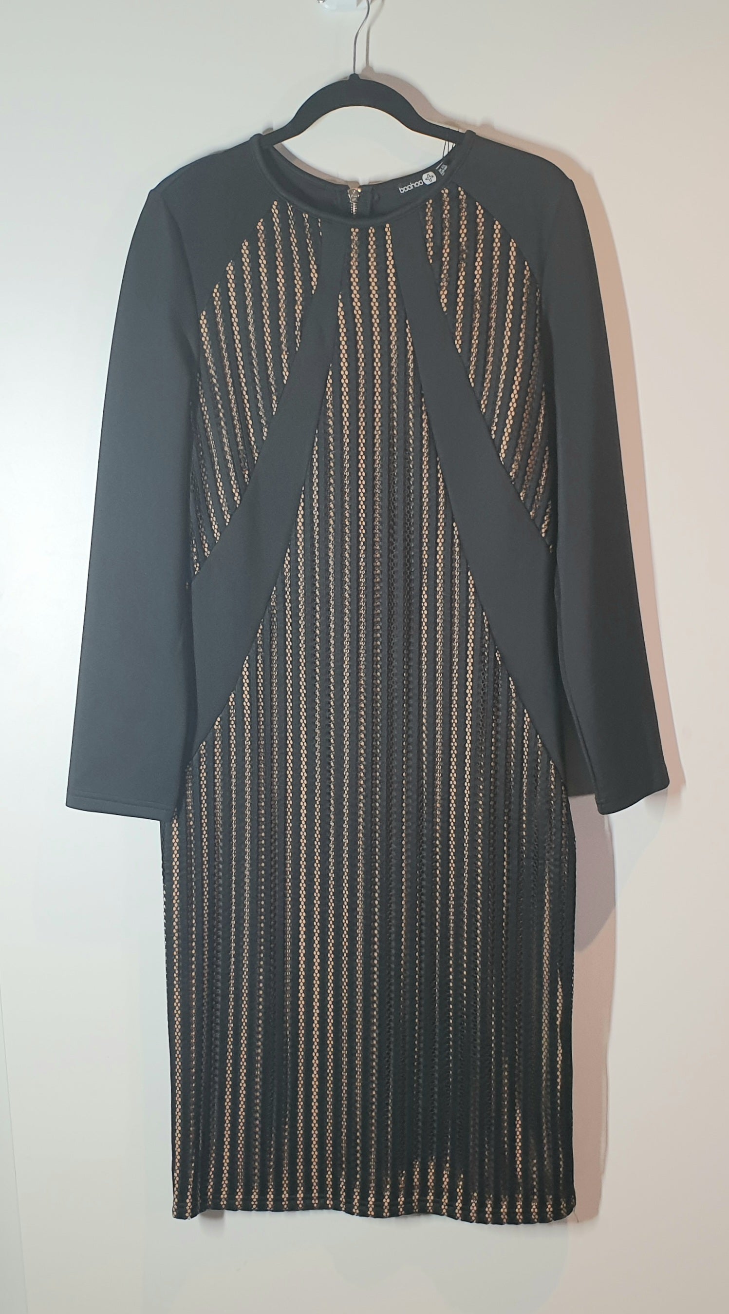 Dark gray dress with geometric pattern on a hanger against a white background