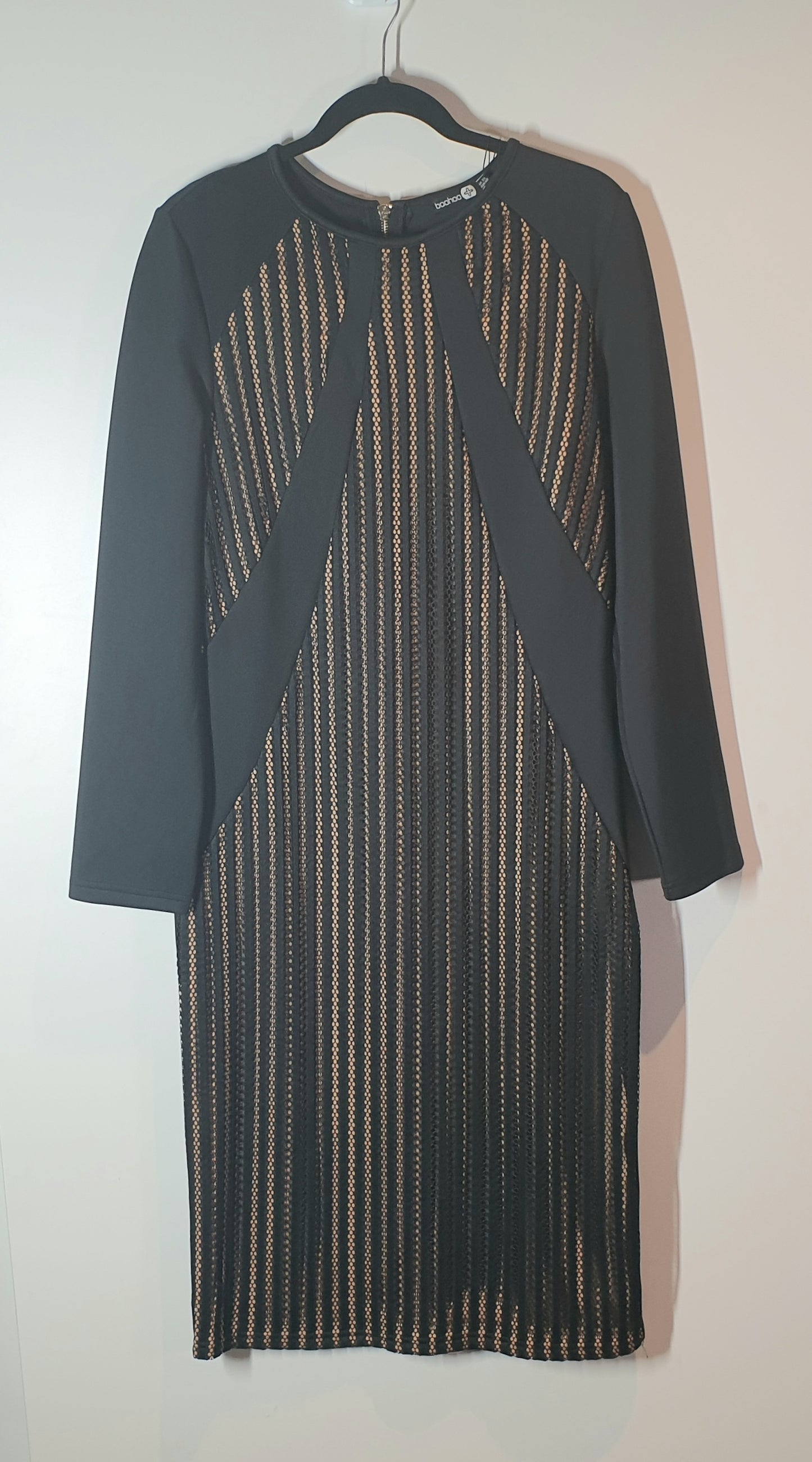 Dark gray dress with a patterned overlay on a hanger against a white background