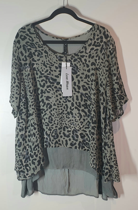 Leopard print top on a hanger with a visible brand tag against a white background