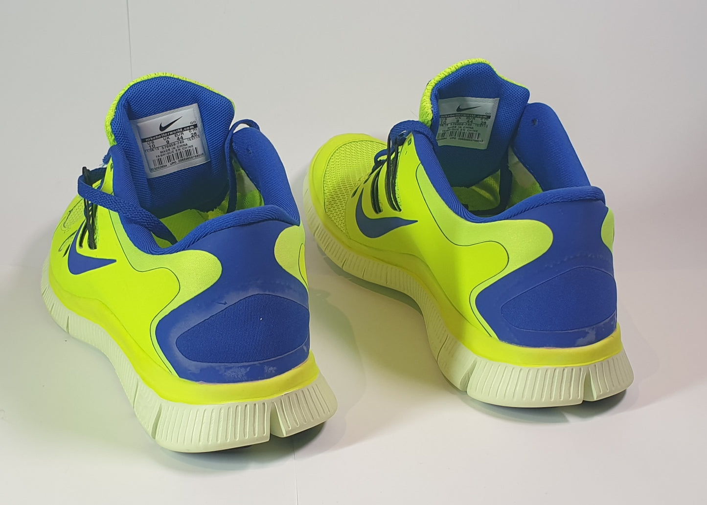 Nike Free 5.0+ running shoes in a volt (neon yellow/green) and blue