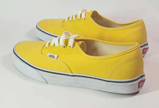 Yellow Vans sneakers on a white background