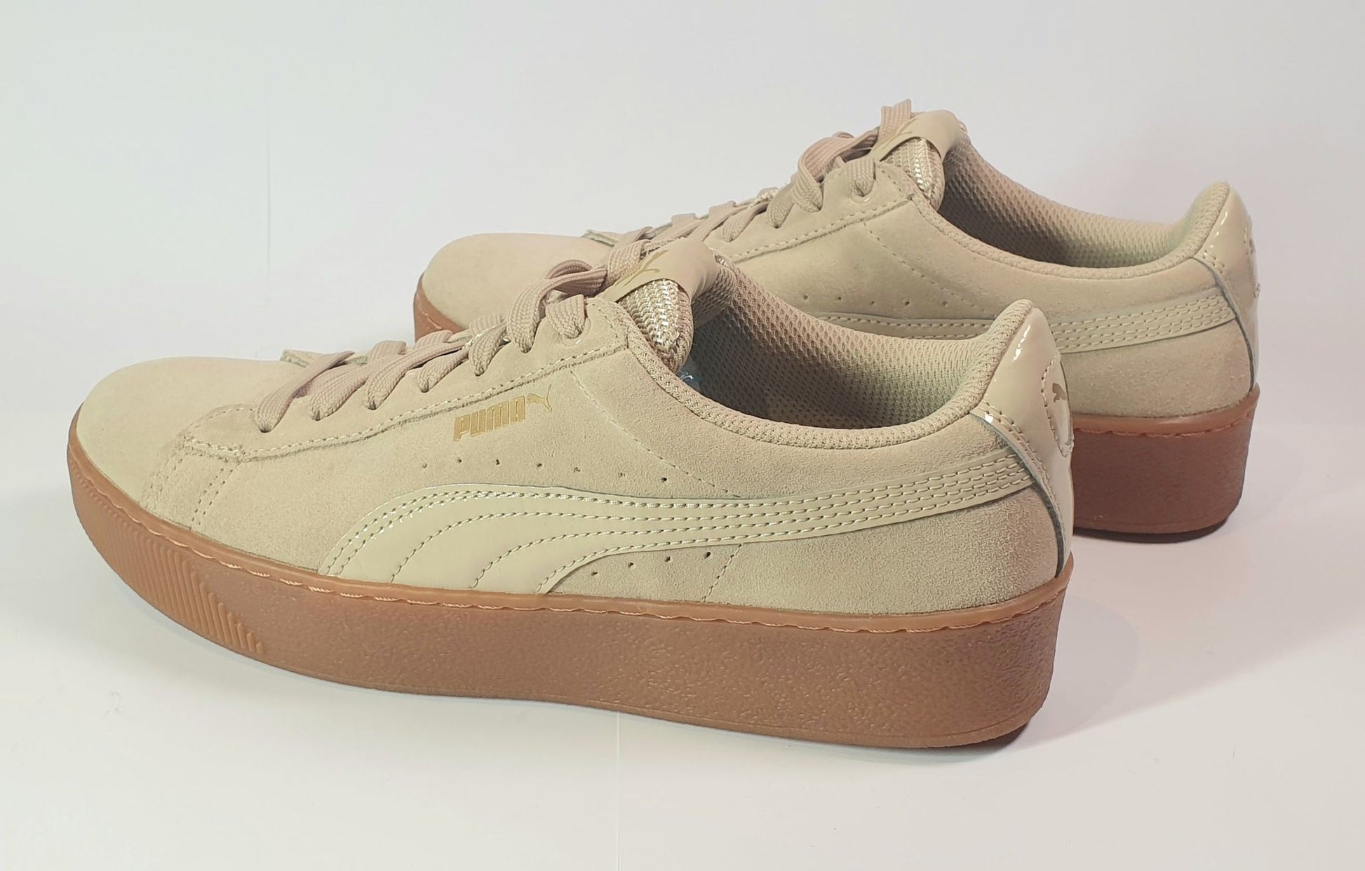 Beige sneakers with brown soles on a white background