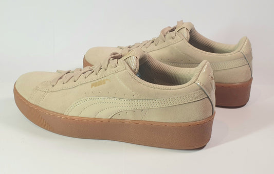 Beige sneakers with brown soles on a white background