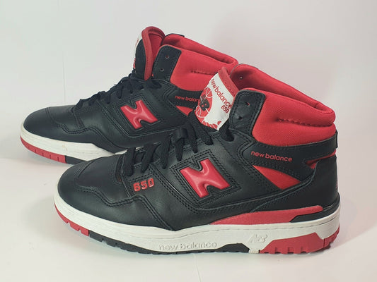 Black and red sneakers with New Balance branding on a white background