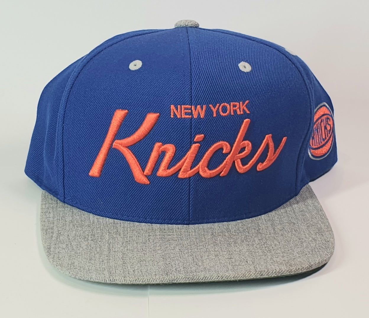 Blue and gray cap with 'New York Knicks' text on a white background