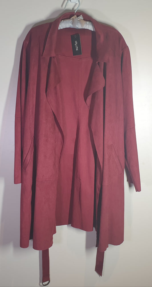 Reddish-brown cardigan on a hanger against a white background