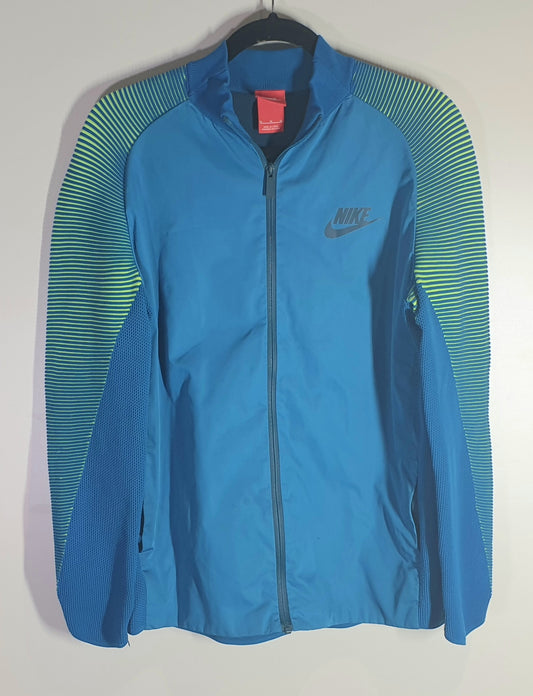 Blue Nike jacket with green accents on a hanger against a white background