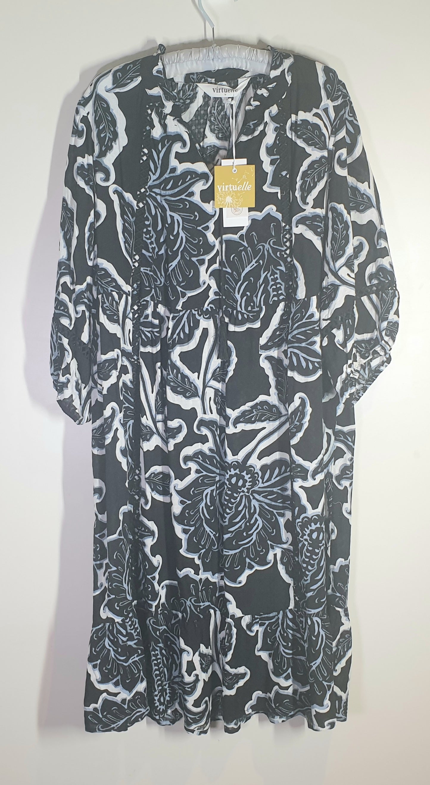 Black floral patterned dress on a white background