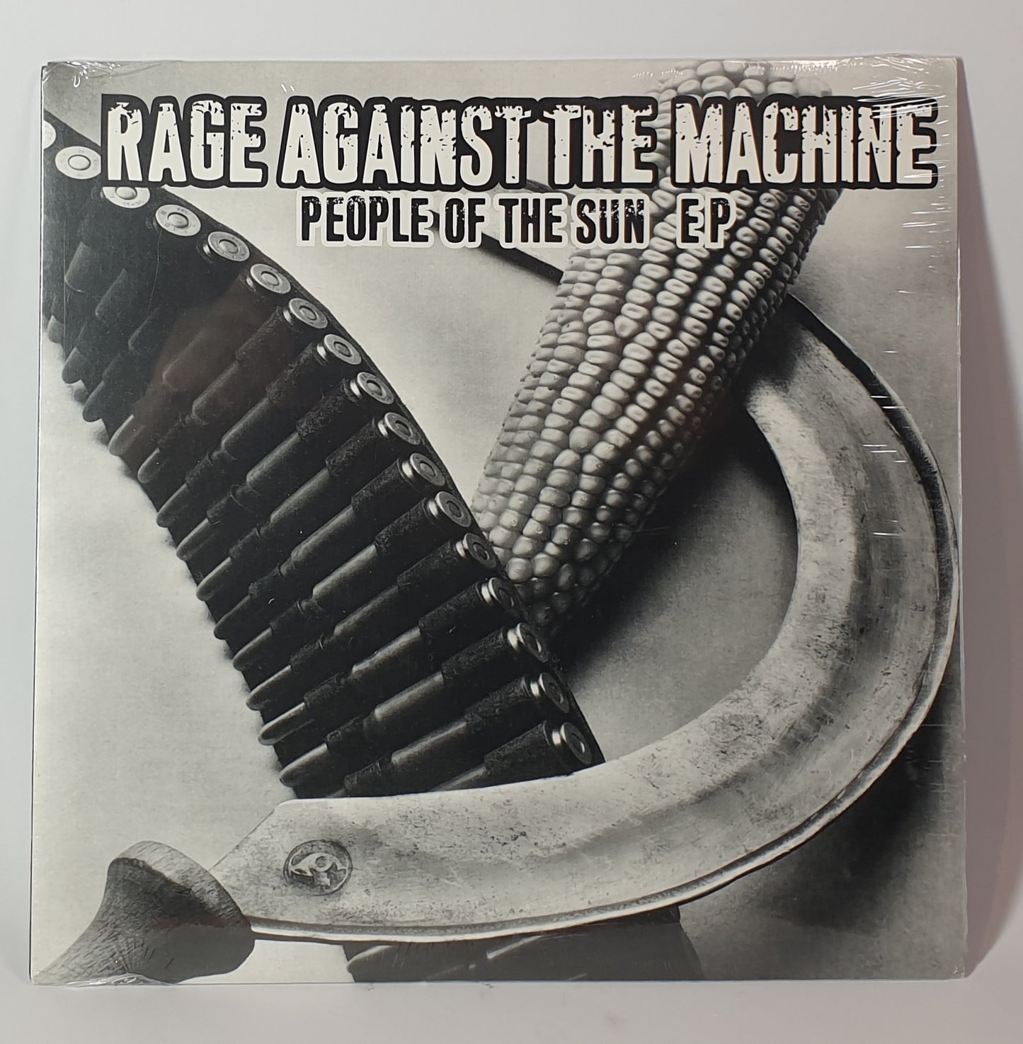 Album cover for 'People of the Sun E.P.' by Rage Against the Machine featuring corn, a belt buckle, and a chain.