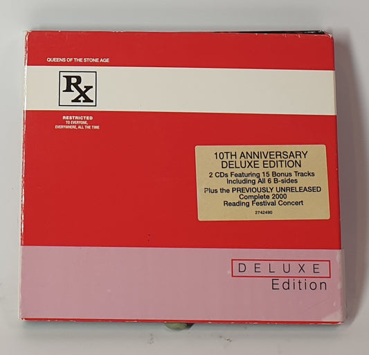 Red and white deluxe edition CD box set with 'RX' logo and text on a gray background, QUEENS OF THE STONE AGE