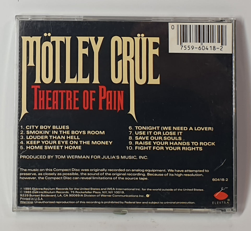 Back cover of Mötley Crüe's 'Theatre of Pain' album on a CD with text and tracklist.