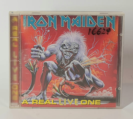 Iron Maiden album cover with a character holding electric guitars on a red background " A REAL LIVE ONE"