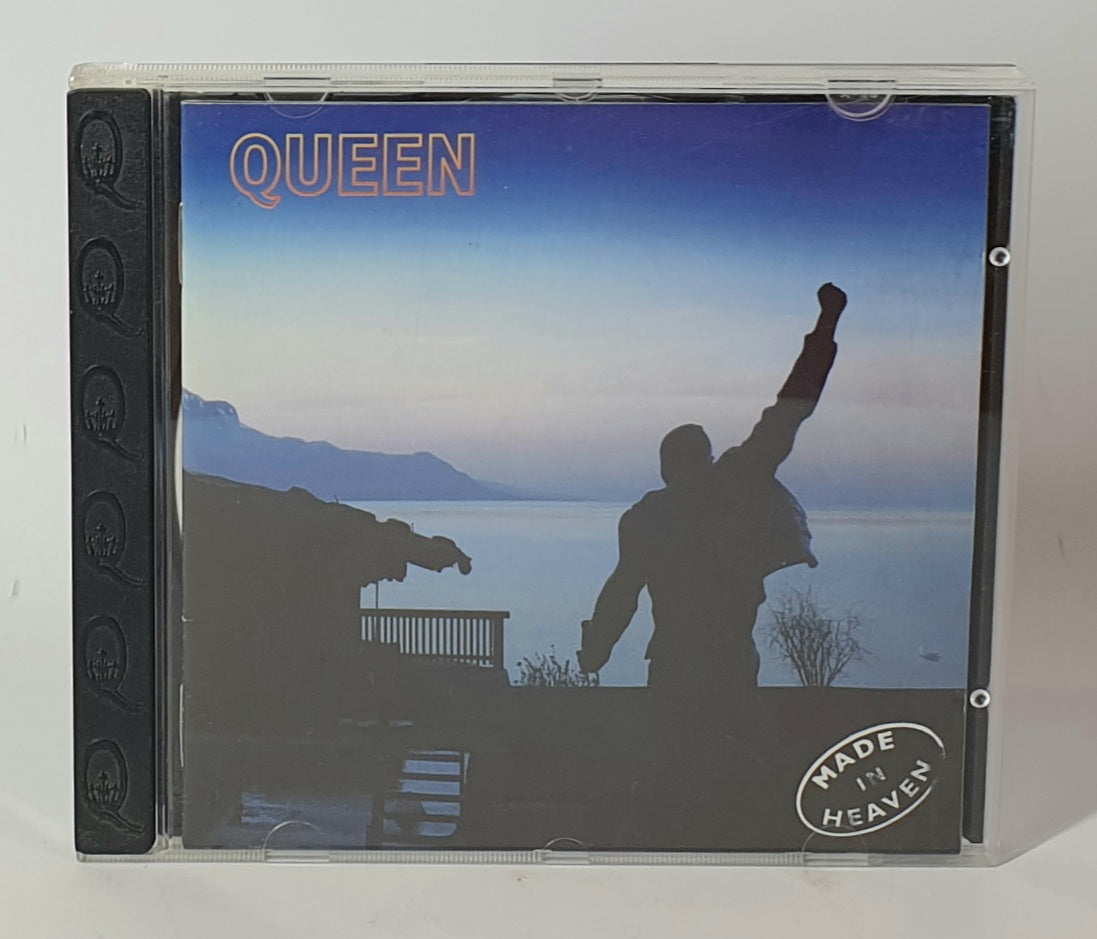 CD case with 'Queen' album cover featuring a silhouette by a lake