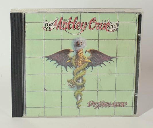 CD cover of Mötley Crüe's 'Dope as a Pill, Dead as a Dog' with snake and wings design.