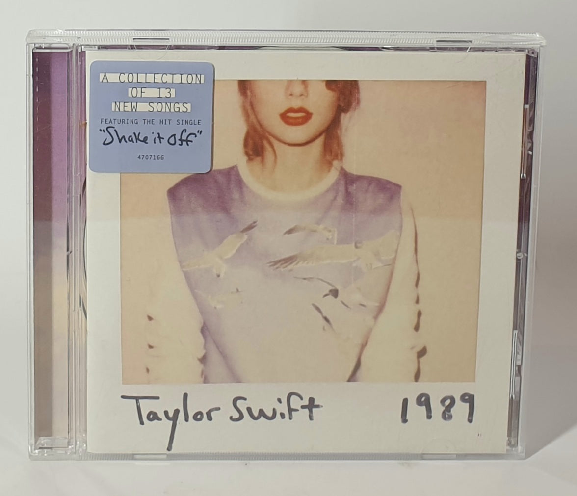 CD cover of Taylor Swift's '1989' with a portrait of the artist on a white background