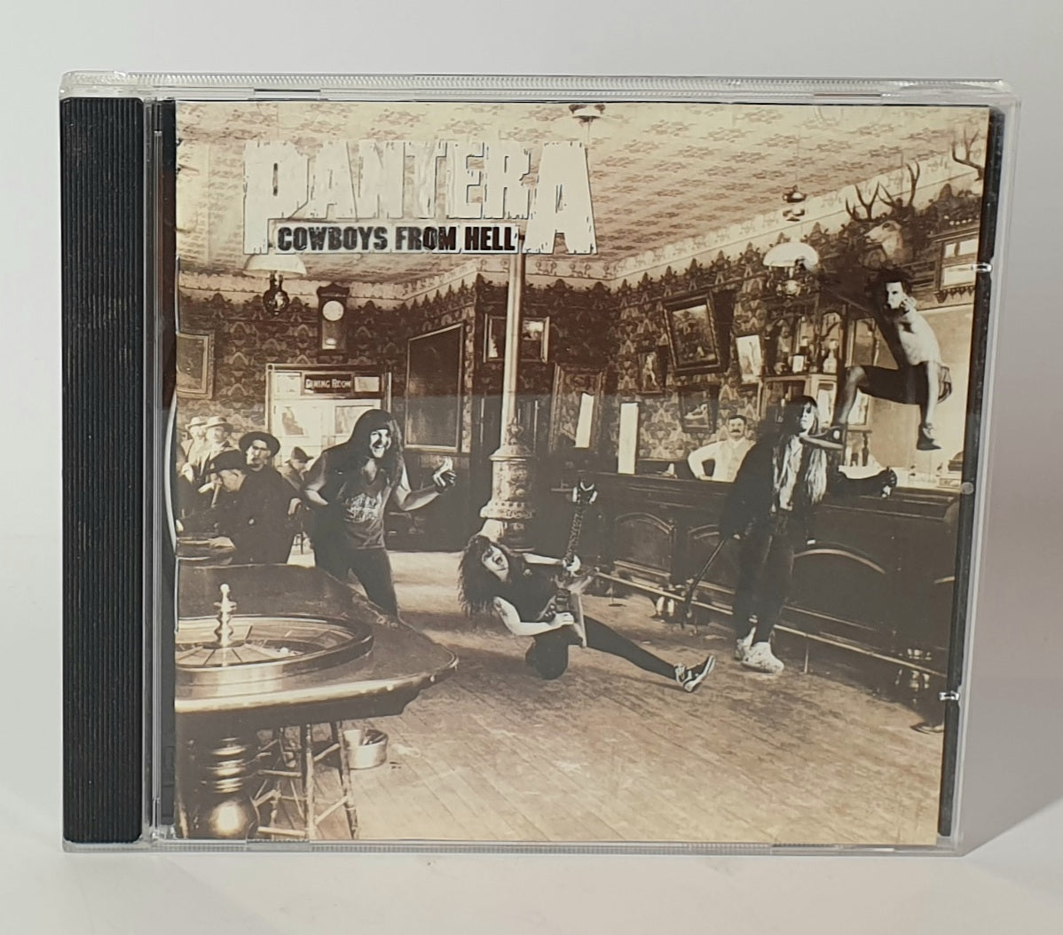 CD cover of Pantera's 'Cowboys from Hell' with black and white illustration of people in a saloon.