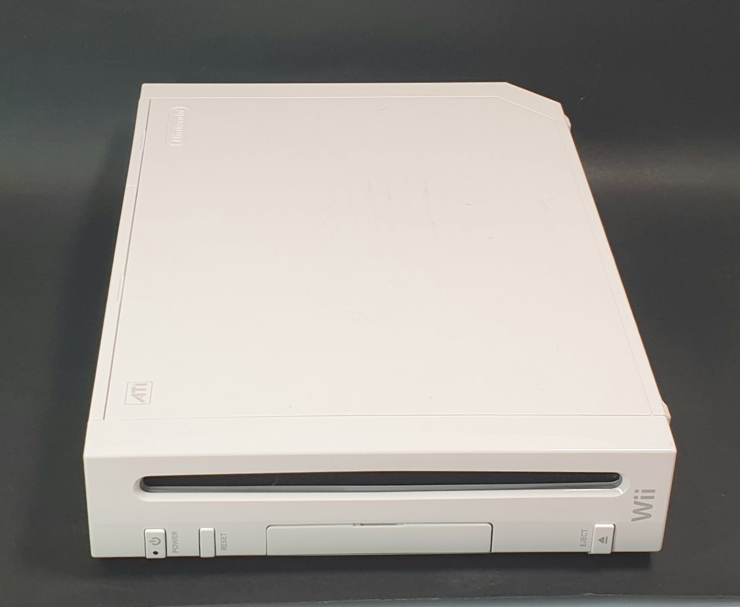 White Nintendo Wii console on a dark gray background
