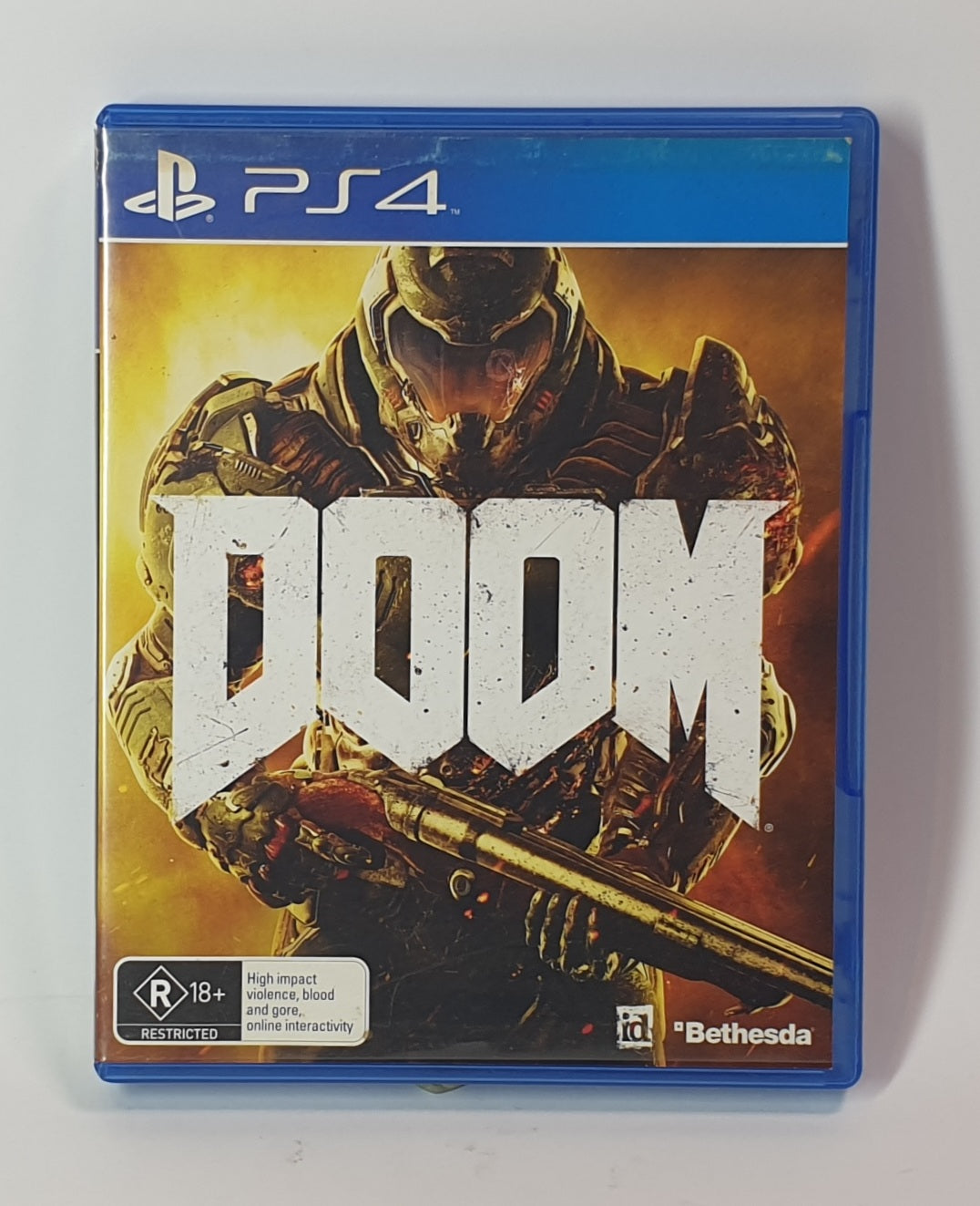 PlayStation 4 game case for 'Doom' with a character holding a weapon on a white background