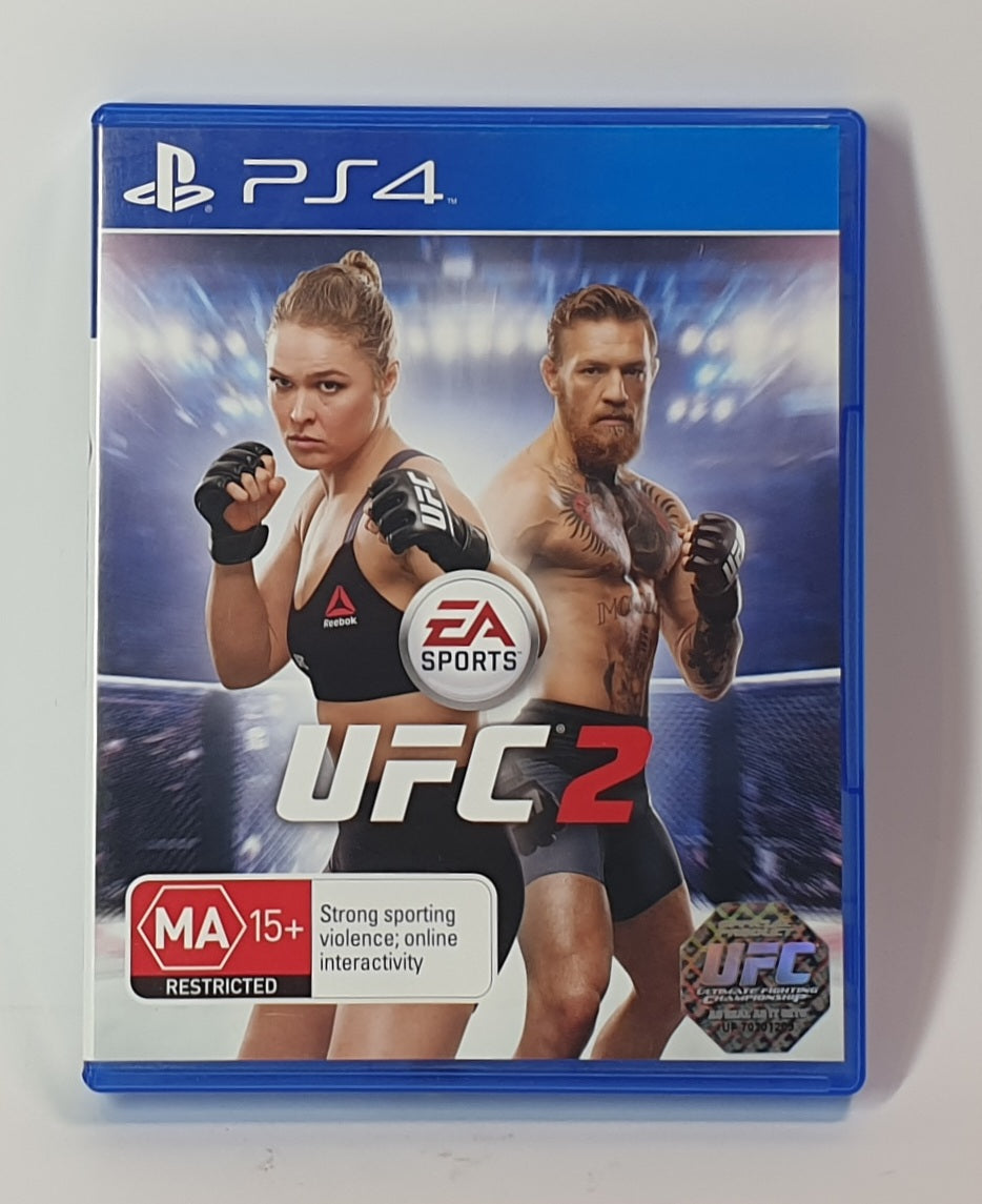 PlayStation 4 game case for UFC 2 featuring two fighters Conor McGregor & Rhonda Rousey on blue background