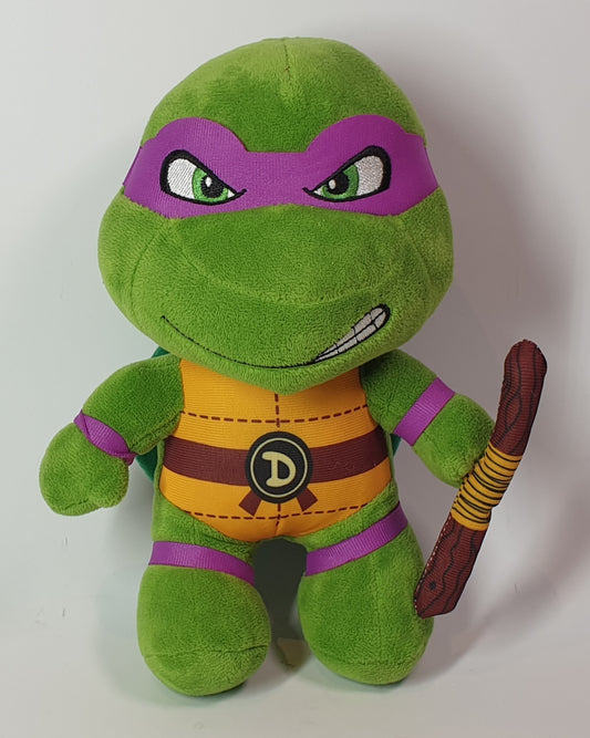 Green plush toy with purple accents and a weapon on a white background