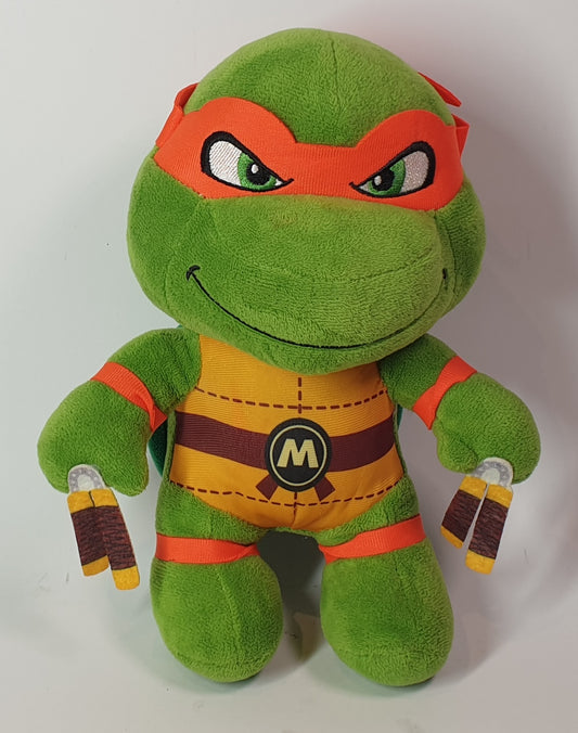 Green plush toy with red accents on a white background ninja turtles