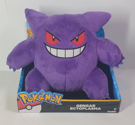 Purple plush toy with red eyes and a wide grin, sitting on a white surface with a gray background.
